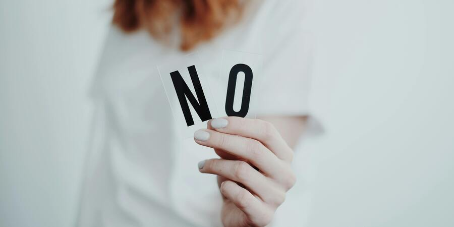 A woman hoiding No symbol in her hands