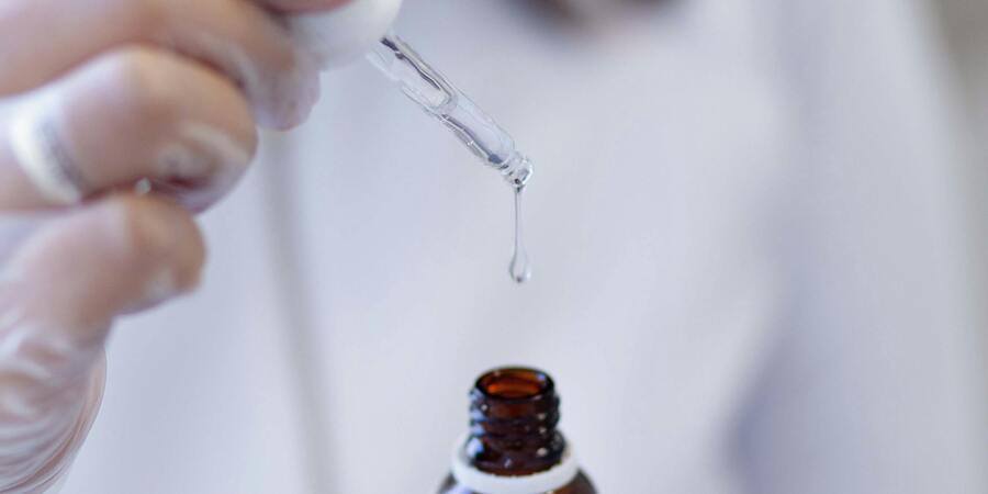 A man taking out oil blend from bottle