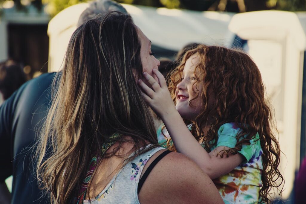 A women is showing affection to her child.
