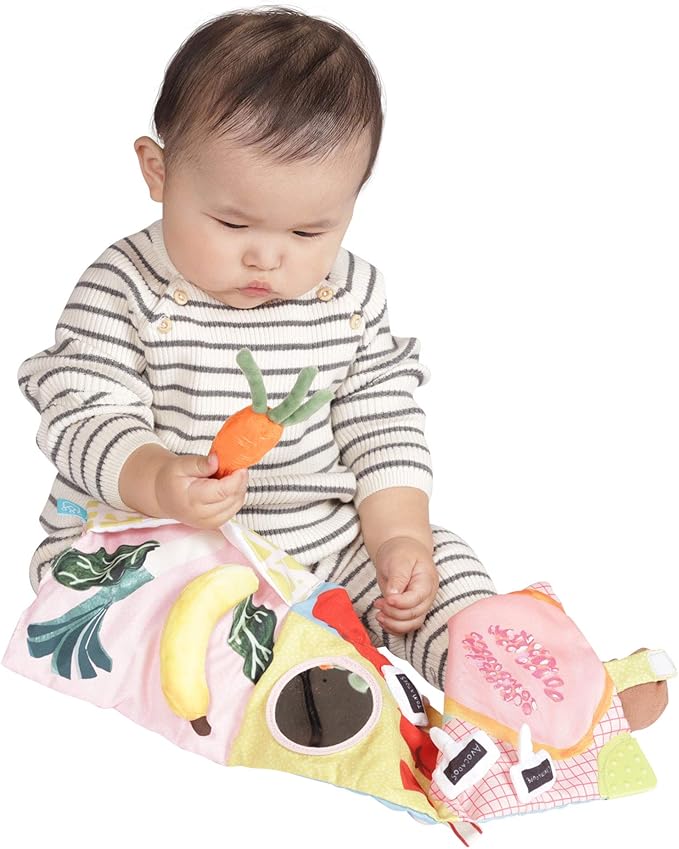 Baby is curiously looking at the vegetables made from clothes .Best sensory toy for his cognitive development.