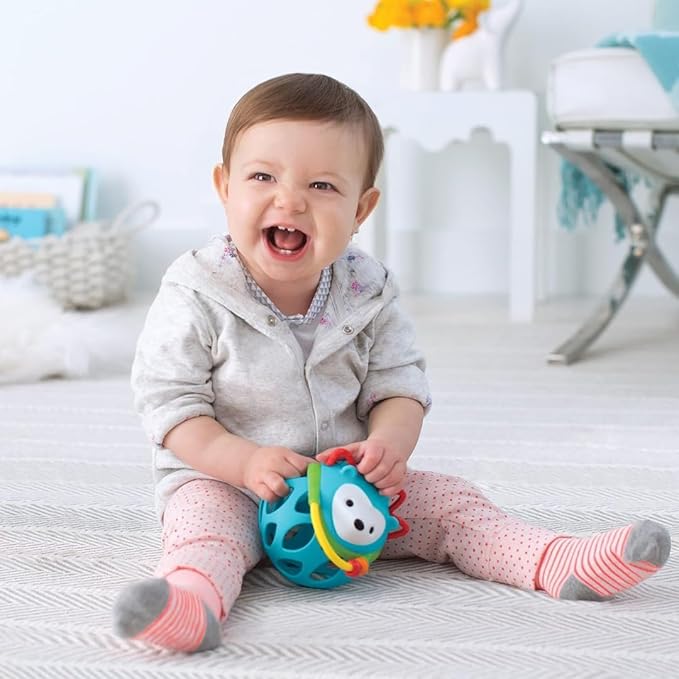 The baby with Skip Hop Explore And More Roller .Baby is laughing during which her teeth are showing . Best sensory toys for crawling babies of age 6 to 12 months .
