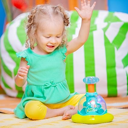 A toddler raise her hand to push the bright star press and glow spinner happily. A best sensory toy for toddlers to teach cause and effect concepts.